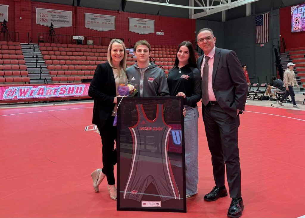 Keith, Angela, Emma, and Andrew Fallon at Sacred Heart University’s senior day wrestling event, celebrating Andrew’s final season before a meet.